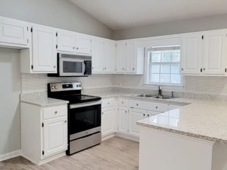 Image of a kitchen with white cabinets