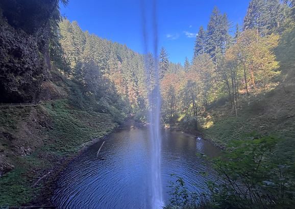Waterfall set against brilliant blue early fall sky