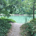 A path from the woods which leads to a secret river lair with sparkling, turquoise water