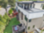 Aerial view of modern luxury home with rooftop deck