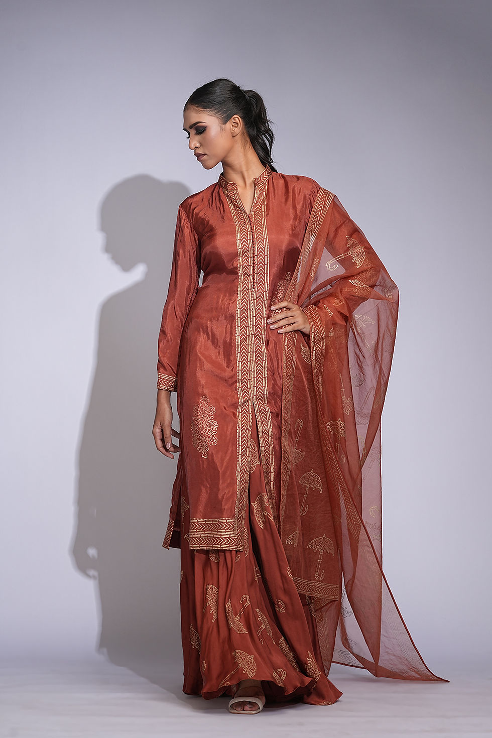 Orange silk sharara set with gold metallic hand block print and organza dupatta by SHRUTI S