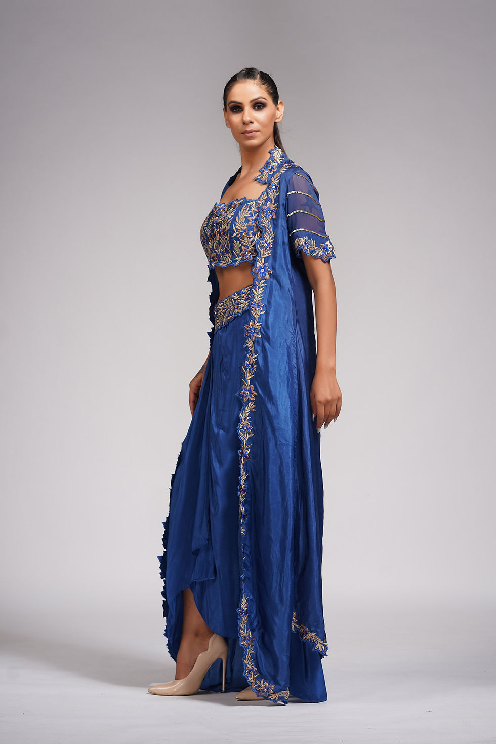 Thumbnail: Model wearing a royal blue dhoti outfit with a silk embroidered cape and scalloped edges