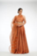 Burnt orange silk lehenga with metallic gold hand block prints by SHRUTI S