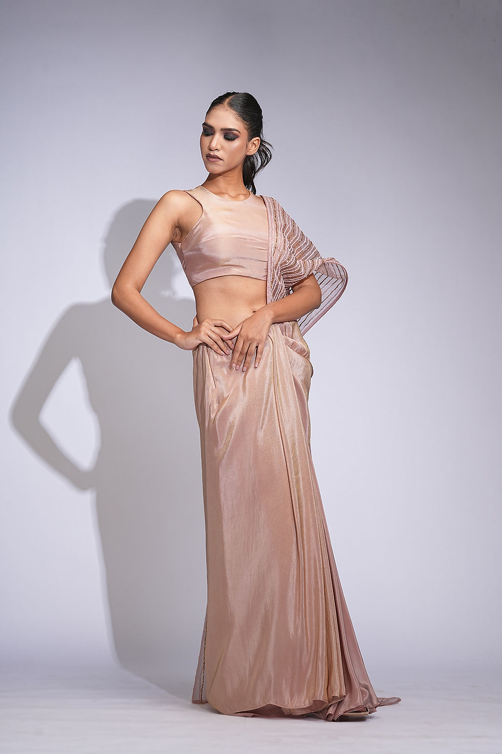 Thumbnail: Model in rose gold pre-stitched saree gown with upcycled sequins and gold blouse – designer festive wear by SHRUTI S