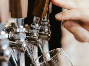 Bartender pouring beer from a tap, the task that requires a Class 12 MAST permit