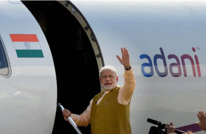 Source: The Indian Express // Modi waves while boarding Adani jet to Delhi days before 2014 election results