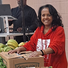 FTPP volunteer smiling at food drive event table 