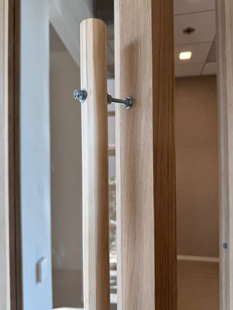 A closeup of a screw connecting two planks of wood. 