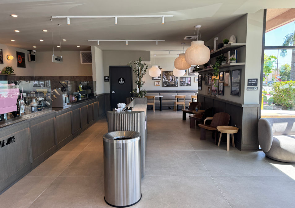 Wide interior view of Joe & The Juice featuring custom millwork, seating, lighting, and branded café environment.