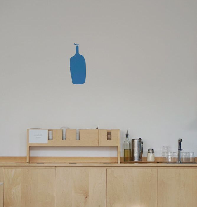 A custom trash receptable and beverage station at Blue Bottle Coffee.