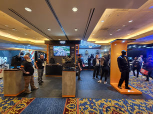 A trade show booth featuring a mannequin wearing tactical gear.