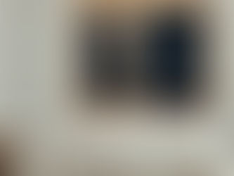 Cozy bedroom with white bedding, two wooden nightstands, and a lit lamp. Full moon and stars visible through open window, creating a serene mood.