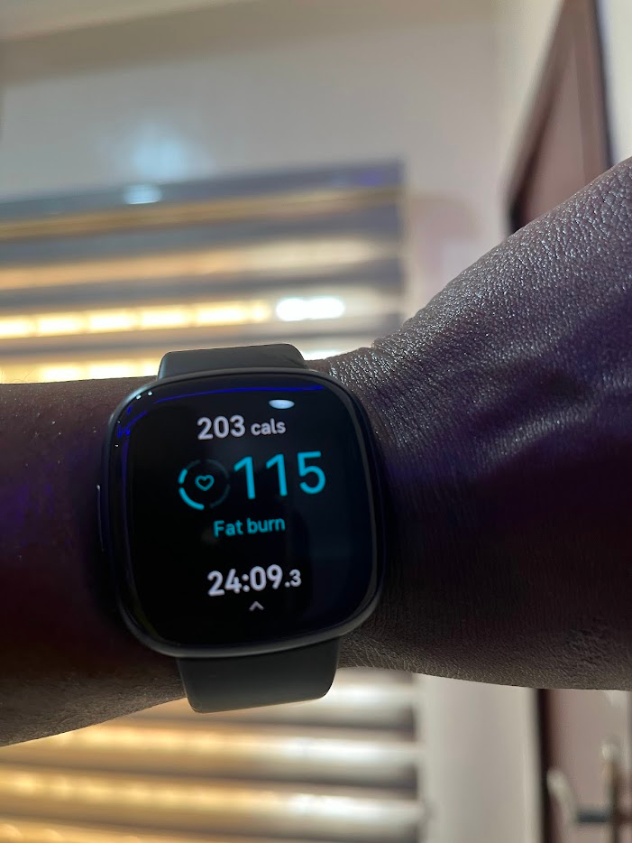 a fitbit watch showing workout stats