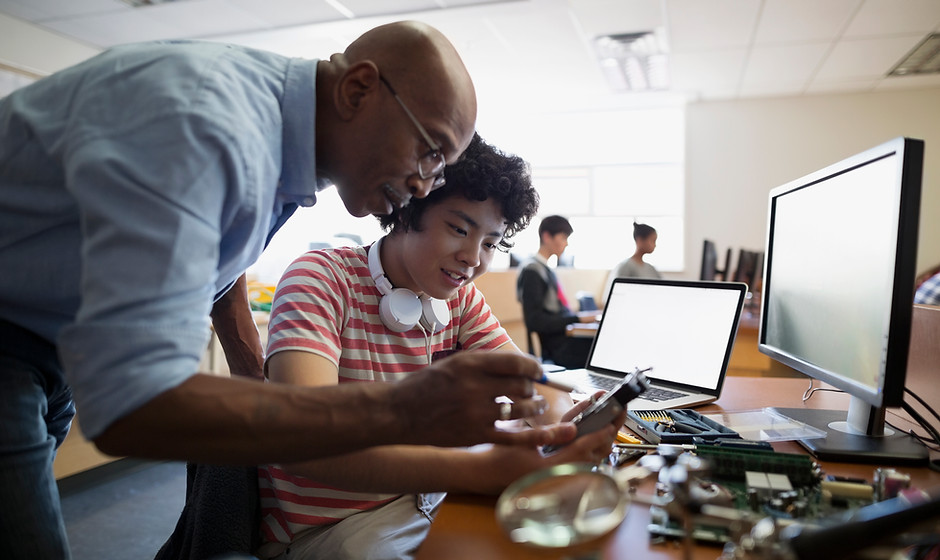 Teacher Assisting a Student