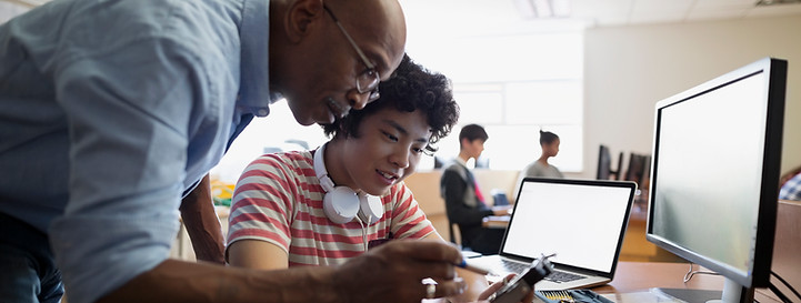 Teacher Assisting a Student