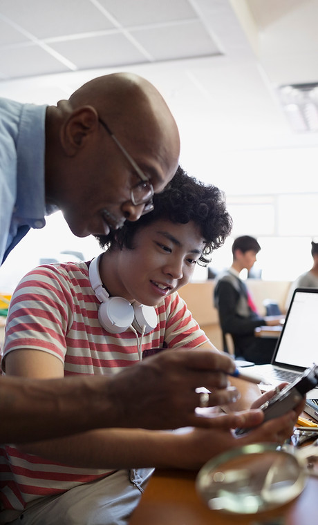 Teacher Assisting a Student