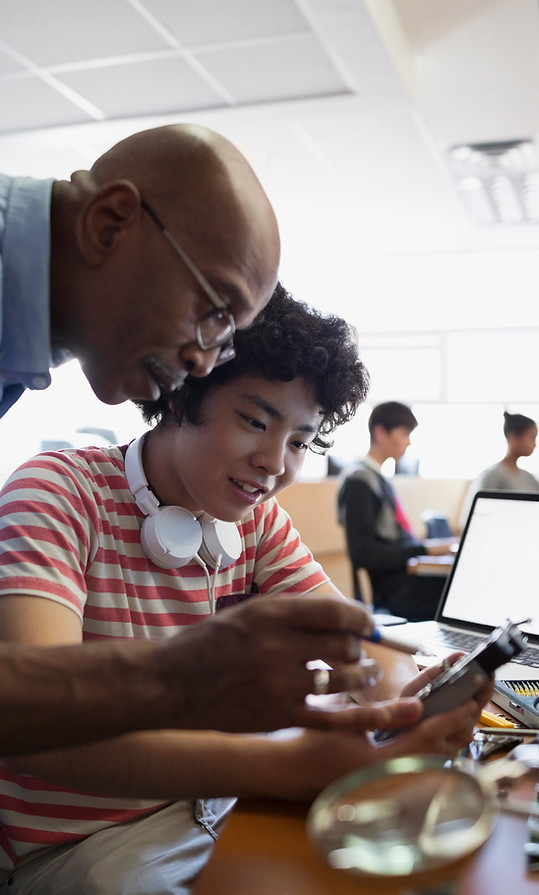 Teacher Assisting a Student