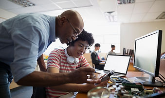 Teaching helping student at computer