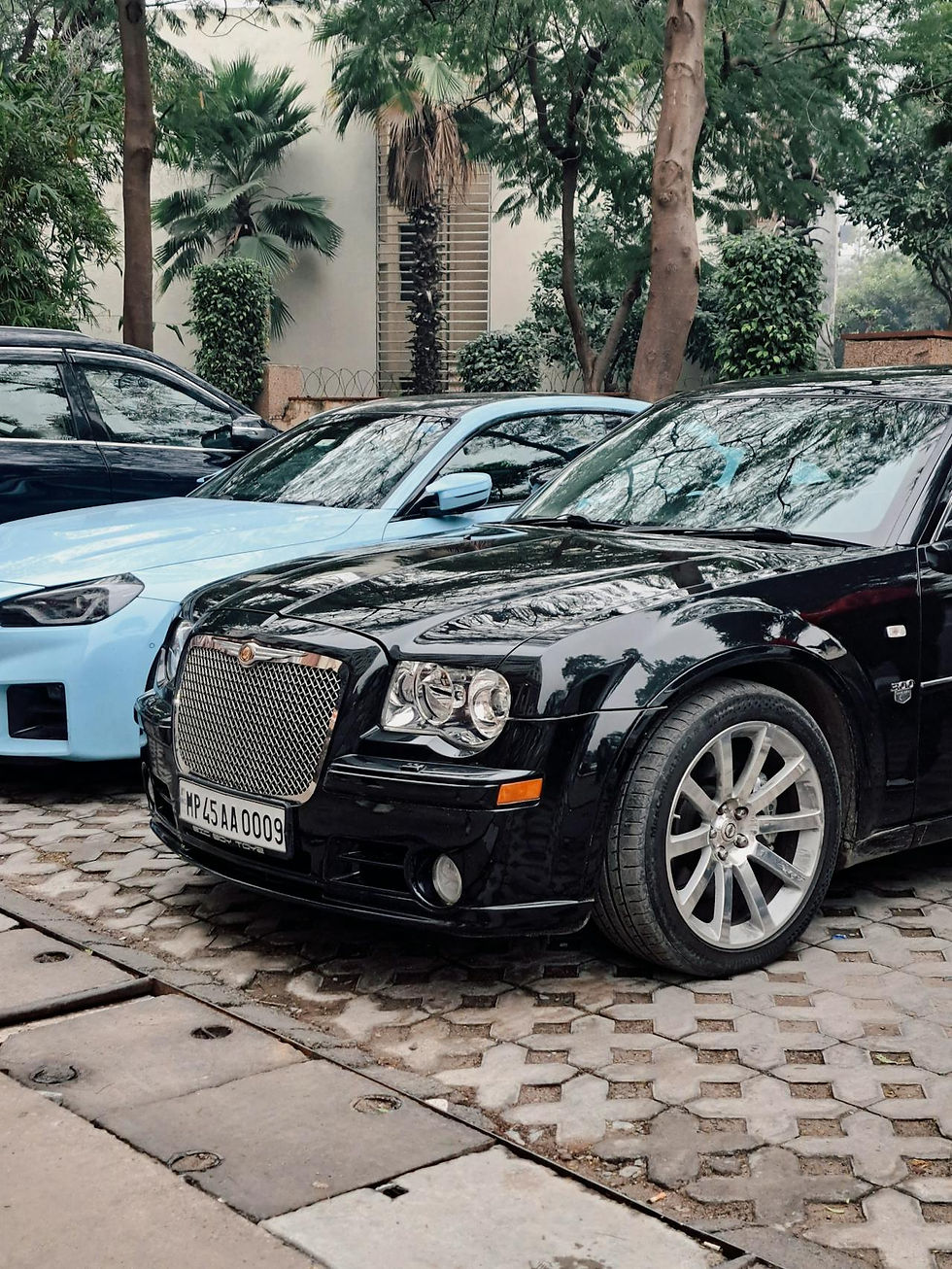 Cars parked in paved driveway