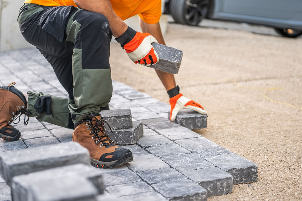 Worker laying pavement blocks