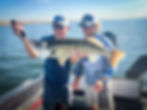 Alan Evans and a client with a walleye fish