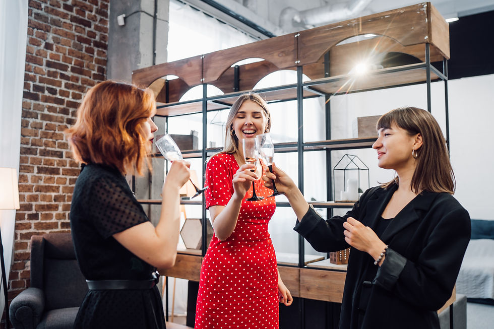 Three women toasting with champagne glasses at a party