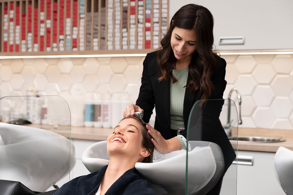 Hair stylist washing client's hair at Beauty Salon