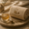 Rolled towel with Maison Lapé logo, tea, and spoon