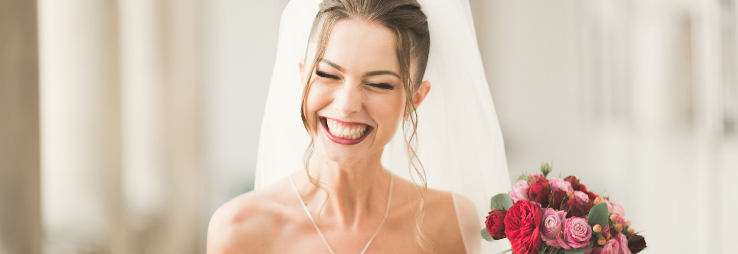 girl posing and smiling with bouquet