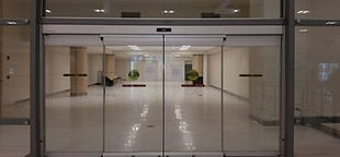 Automated glass door system of a commercial building