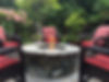 An outdoor fire pit surrounded by lawn furniture