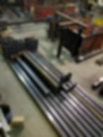 Metal profile of the pipe lies on the shelves in the workshop