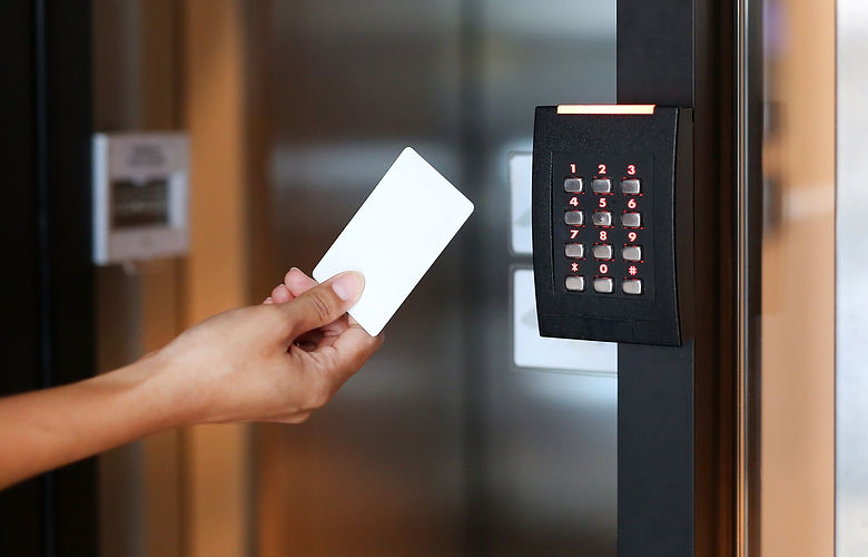 young woman holding a key card to lock and unlock door