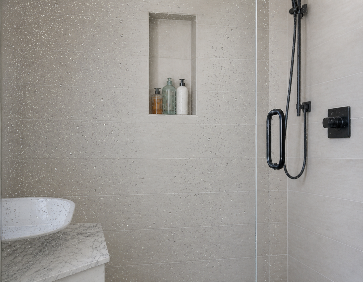 Shower screen after hydrophobic coating — clean glass with water beading off