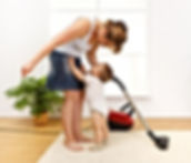 Mom smiling at Child with Miele vacuum