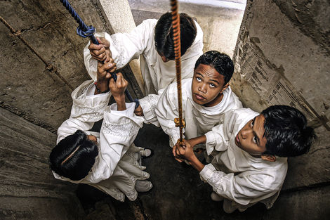 Fotoshooting auf den Philippinen von Messdienern beim Läuten der Glocken zum Gottesdienst.