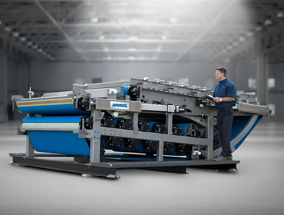 Large industrial machine labeled ANDRITZ with a blue conveyor and a technician operating it in a spacious factory setting