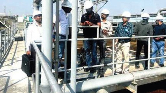 Engineers inspecting a food processing ETP during an industrial odour control and gas analysis survey
