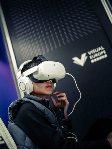 Social media photo: boy sitting in VR glasses at Marketing Summit.