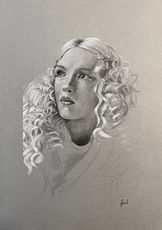 Portrait of a  woman with curly hair looking to the side