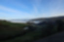 View over a green valley coverd with fog