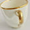 Thumbnail: Derby orphaned coffeecup, white with landscape by Zachariah Boreman, ca 1790