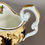 Thumbnail: Samuel Alcock teacup and milk jug, pale yellow, gilt and flowers, ca 1824