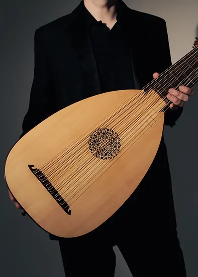 Close up of Toby Carr holding a lute
