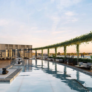 Rooftop pool and lounge at Four Seasons New Orleans overlooking the city skyline, a top destination for a romantic New Orleans vacation.