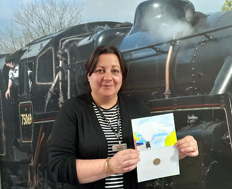 Gem Bilak holding Nicholas Ragan's donation to the Home & Dry appeal in September 2021