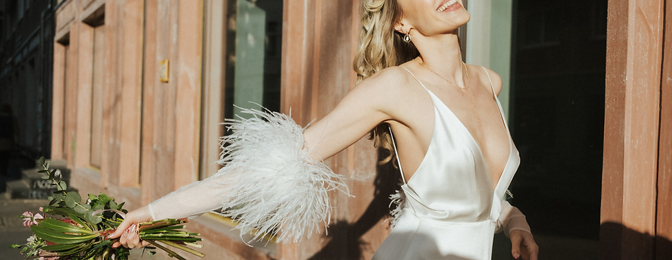 Bride throws her bouquet in the golden sunlight in Berlin