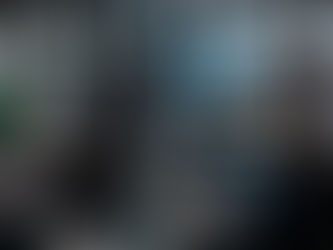 A team of cybersecurity professionals analyzing data on multiple monitors in a high-tech server room.