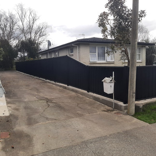 Colour steel fence with sloped section between two different heights