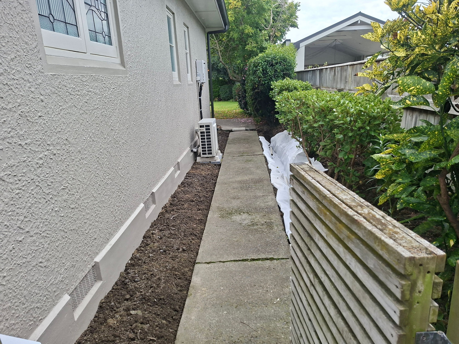 Existing concrete accessway before complete footpath replacement and landscaping improvements.